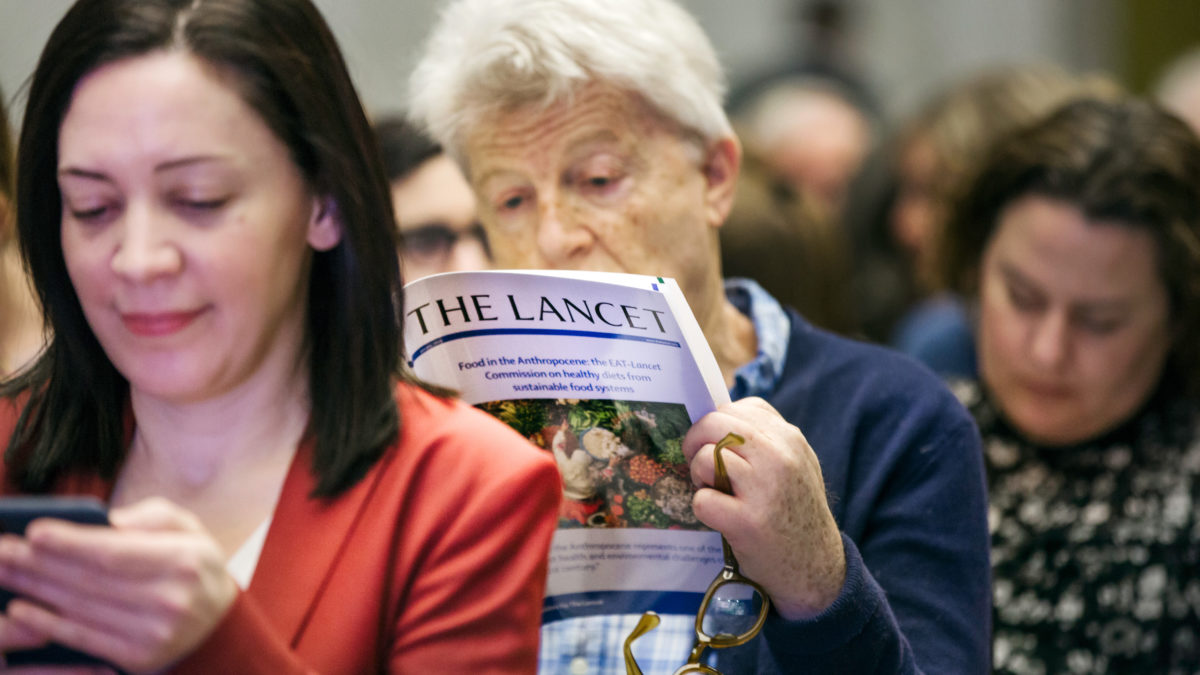 Audience member reading report at the EAT-Lancet Launch, January 2019