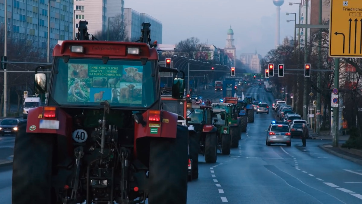 A still from the short film WEUNITE shows farmers driving their tractors to the We Are Fed Up demonstration in Berlin.